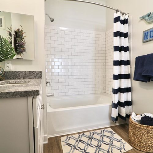 Harbor Heights Bathroom with blue towels with blue and white striped shower curtain